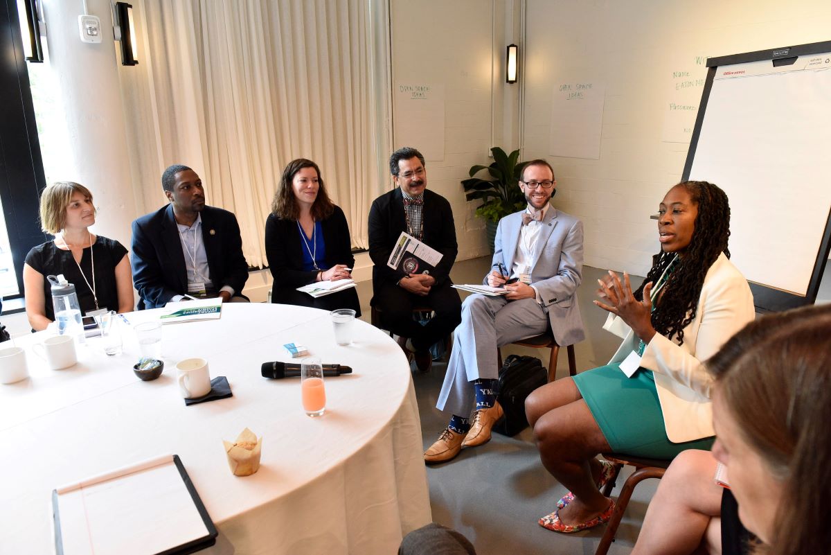 A group of people sitting around a round table
