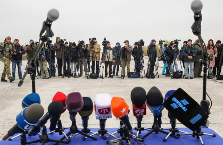 Photo of journalists waiting for press conference to start