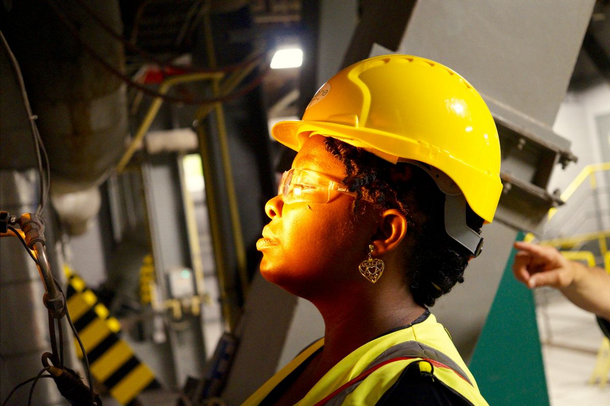 A person wearing a hard hat and safety vest