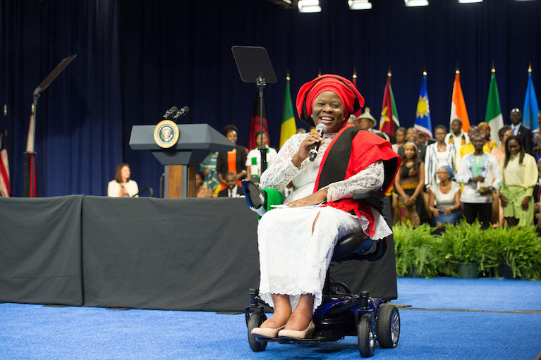 A woman on a stage in a scooter