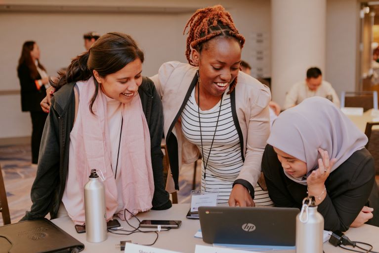 Three women looking at a computer