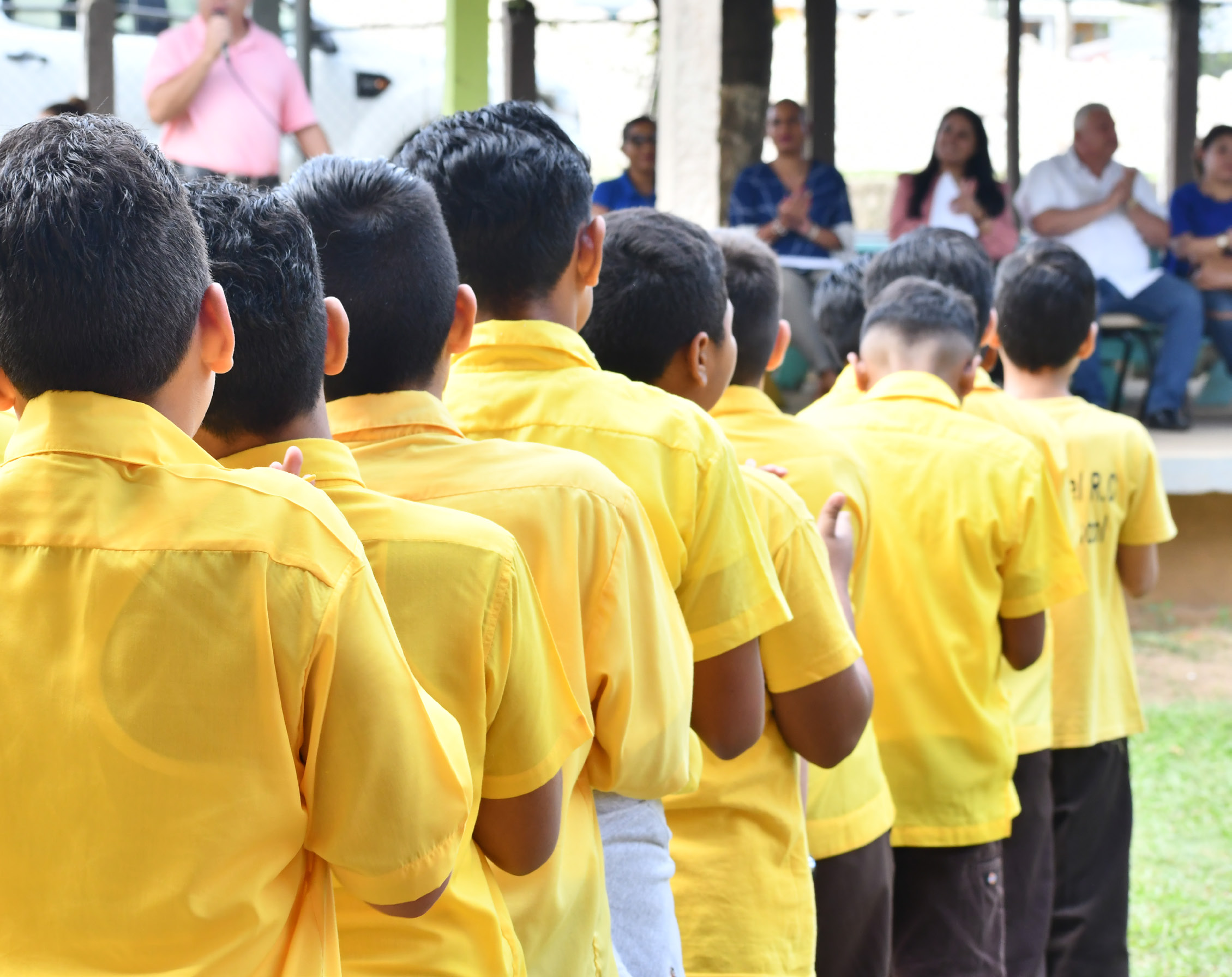 Image of the back view school children in Belize lined up.