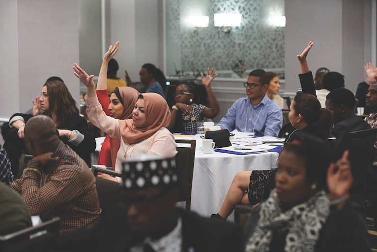 A group of young people raising their hands