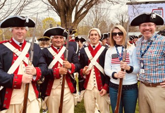 Casey standing with historical reenactors