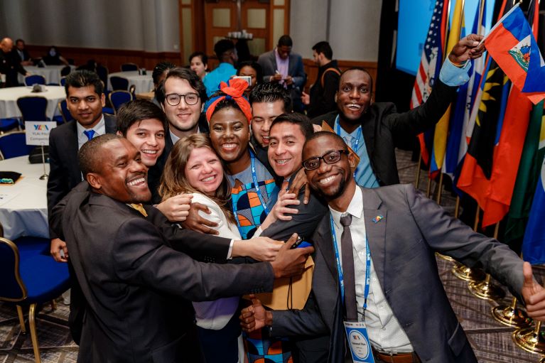 A group of participants smiling and hugging