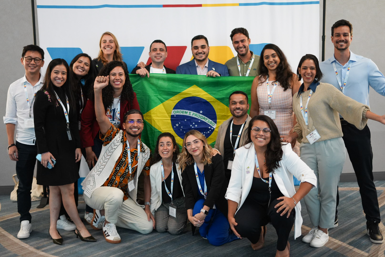 Photo of people smiling with a Brazilian flag