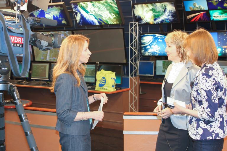 Three women in a news station  