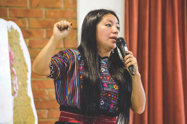 Woman speaks into microphone