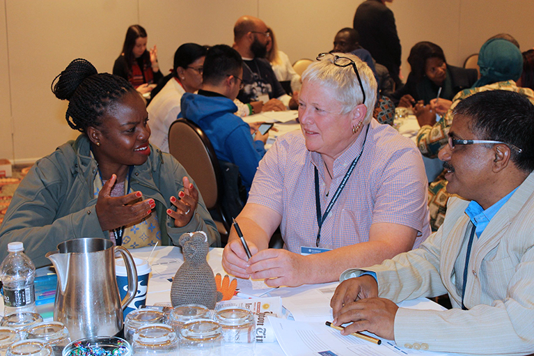 Picture of teachers sitting at a table during a training session. 