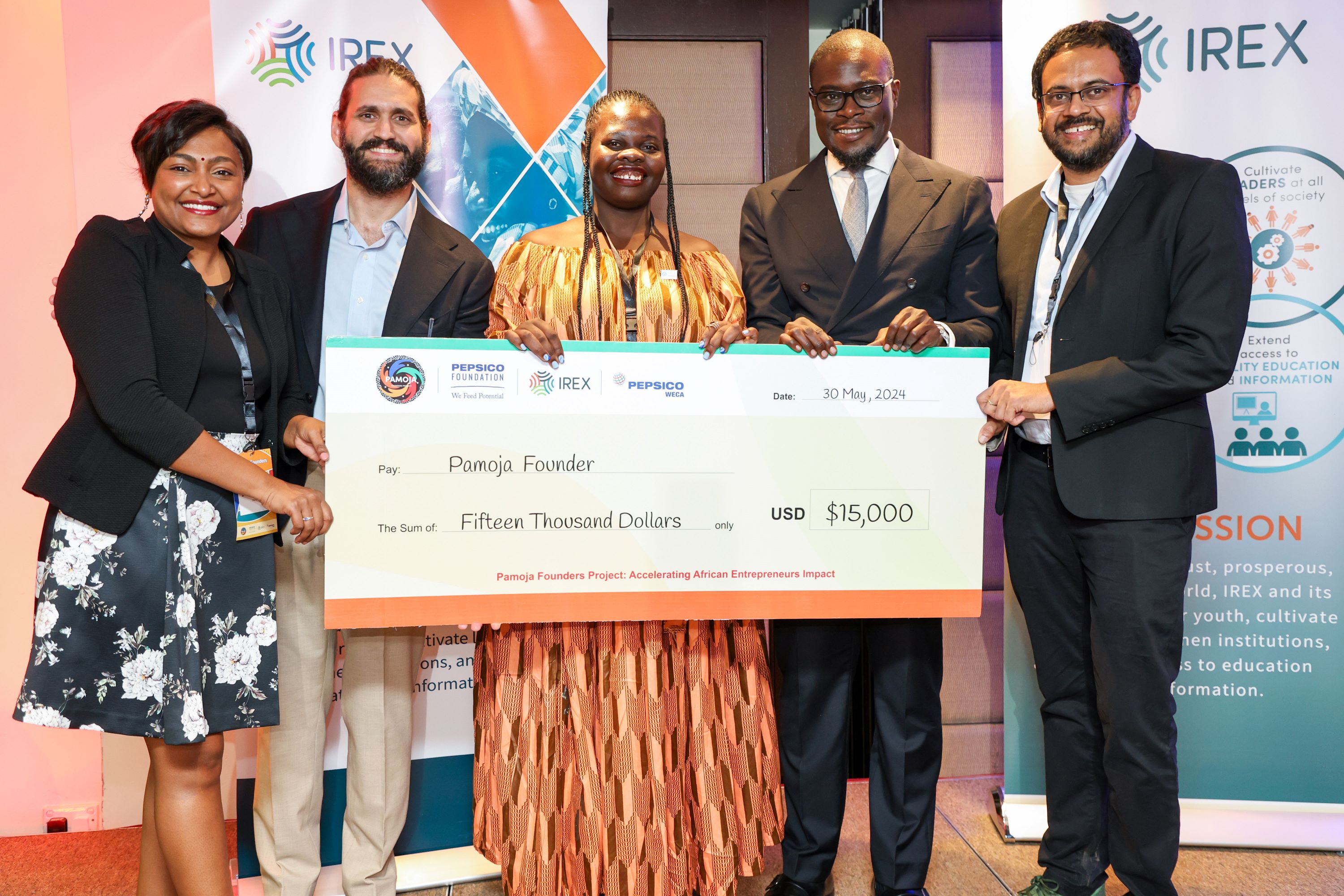 Photo of Pamoja Founder receiving a check from, Governor of Nairobi, IREX and Pepsico Executives 