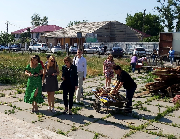 Kristin Lord and others walk around a damaged school 