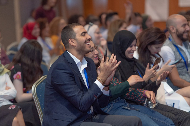 MEPI Alumni sit in audience and applaud