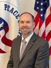 Michael McCabe Headshot in front of U.S. Flag