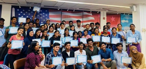 A group of people holding certificates