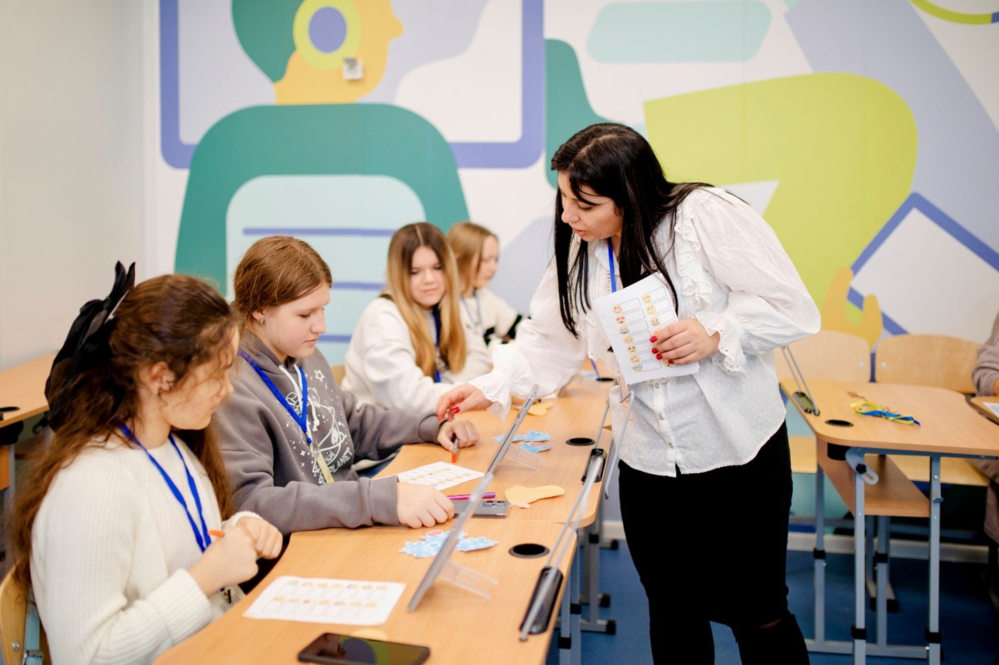 A teacher and four students in a classroom