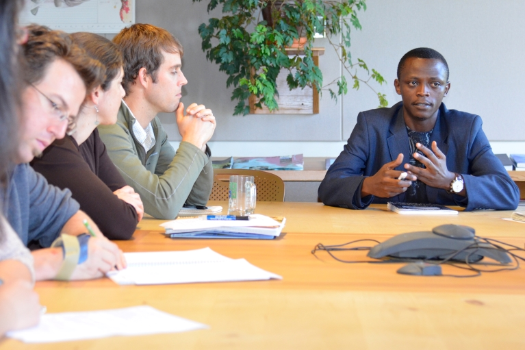 Group of people sitting at a boardroom table.