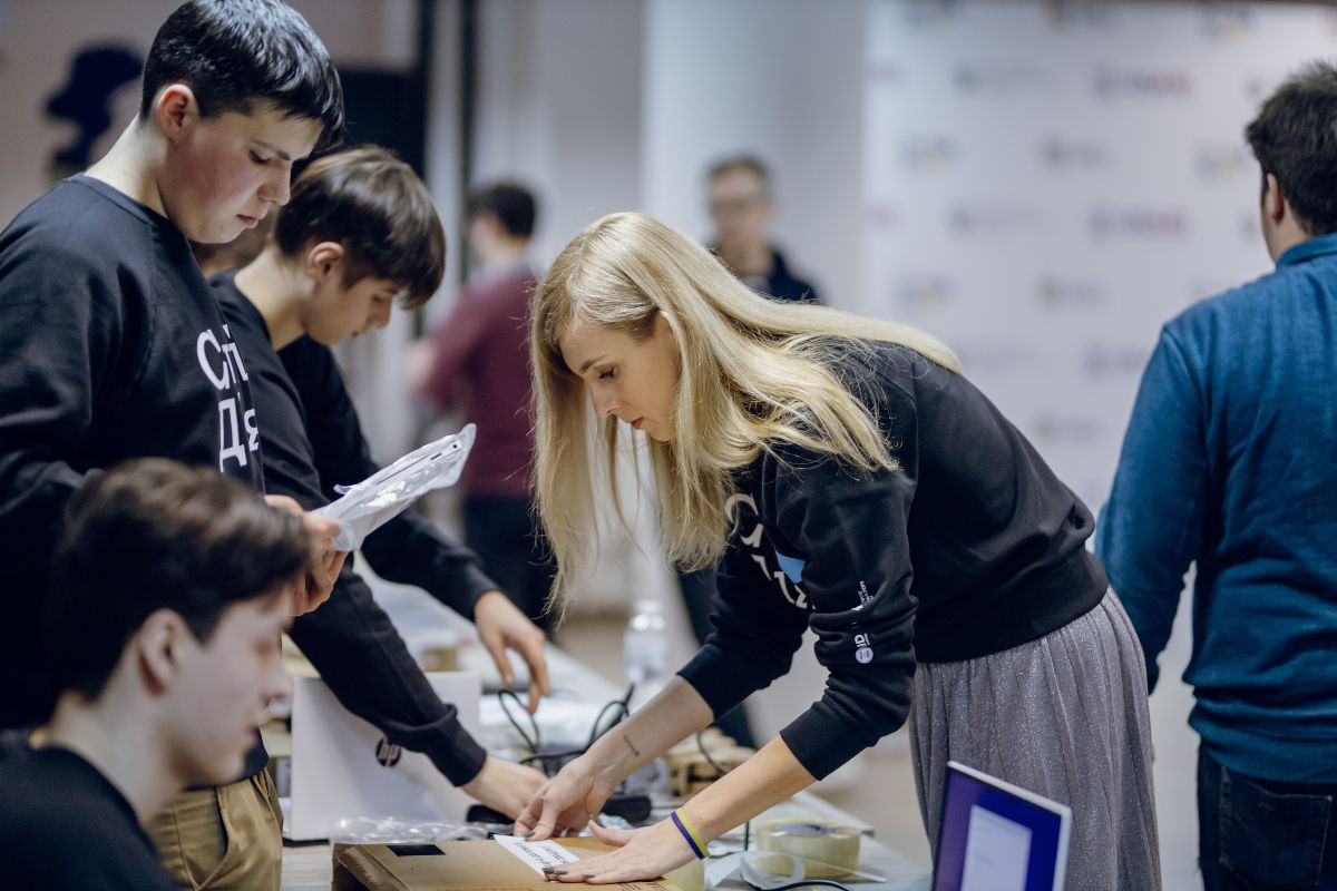 Young Ukrainians prepare laptops for delivery