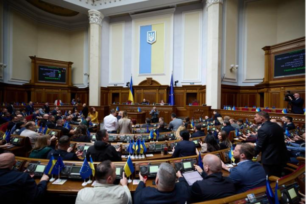 A group of legislators sitting in Parliament.