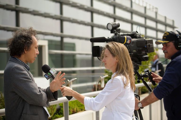 Journalist being interview in front of camera