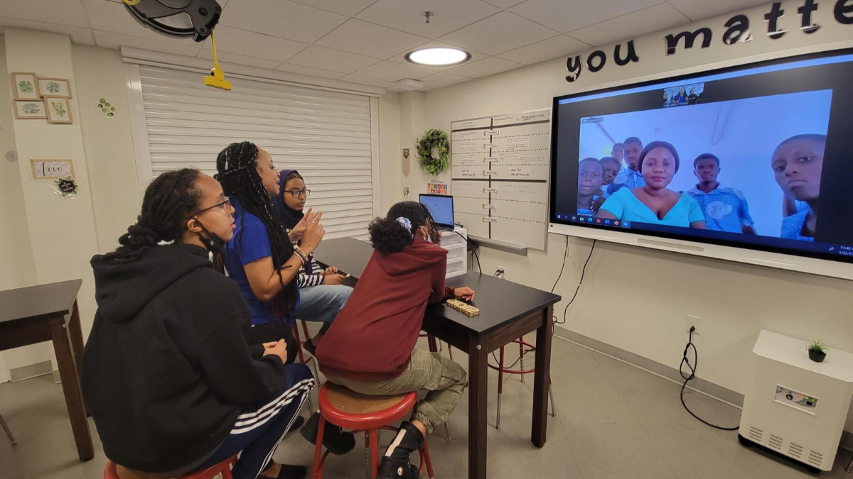A group of people sitting in a room on a virtual call
