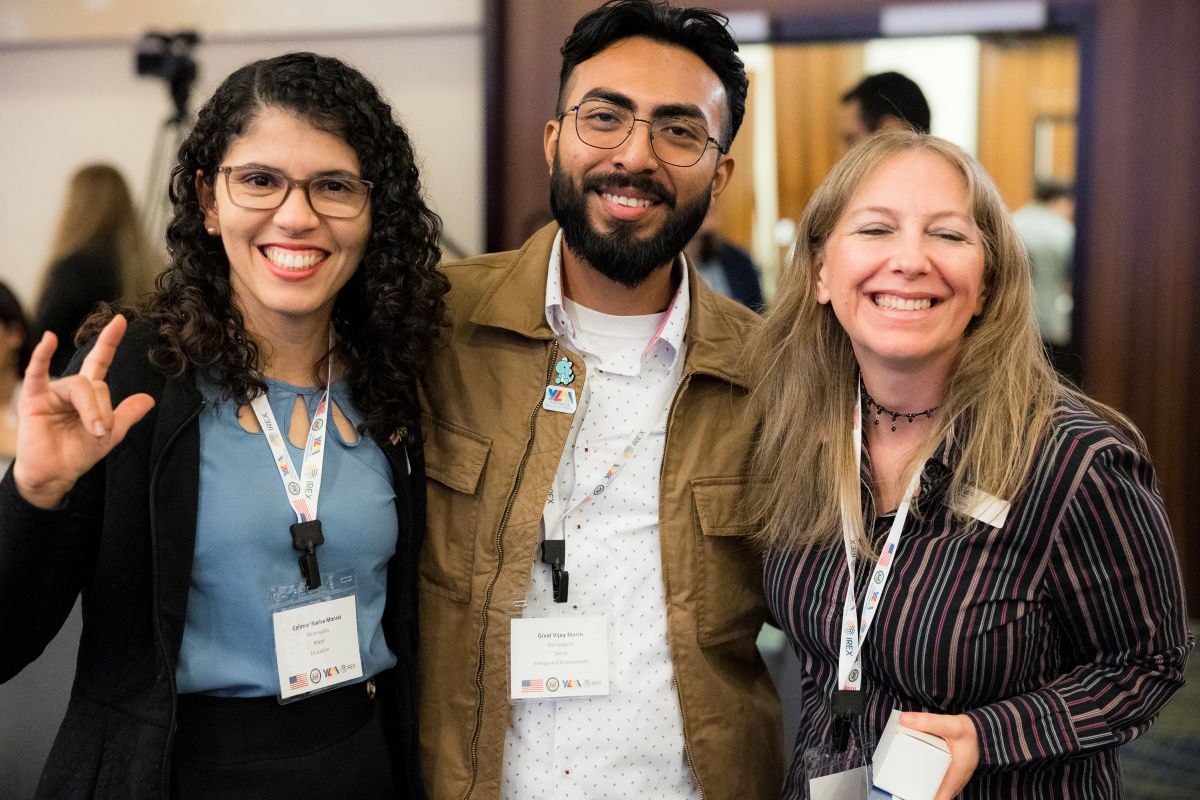 A group of three people posing for a photo
