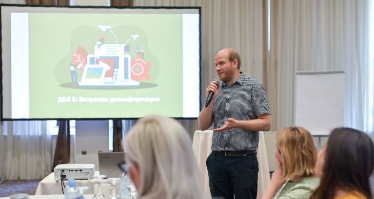 Man holding a microphone as he conducts training