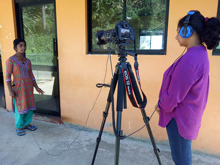 Photo of a journalist with a video camera conducting an interview in Sri Lanka