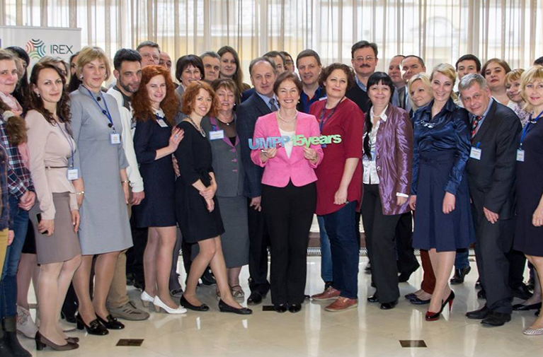 Photo of a group of participants standing in a line and smiling for the camera.