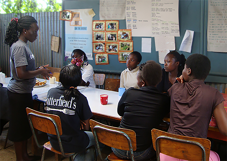 Yvonne action shot instructing teens on peacebuilding
