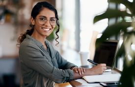 Photo of teenage girl smiling at a desk