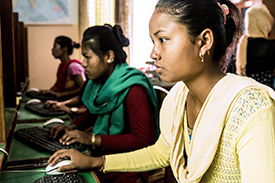 Young women using computers at a READ Center.