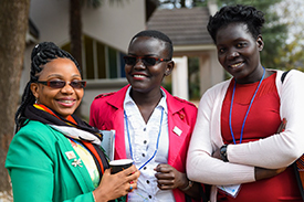 Photo of three participants talking outside.