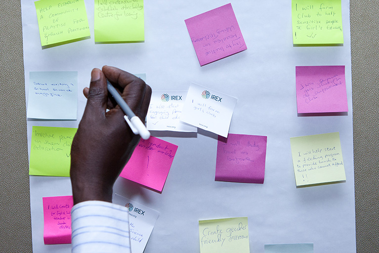 Writing on sticky notes during an activity.