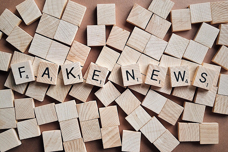 Scrabble pieces that spell the words fake news