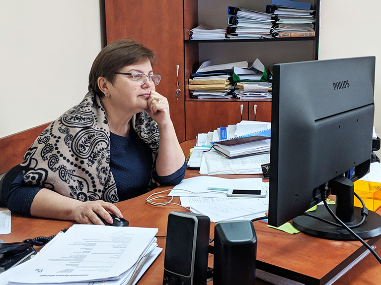 Photo of a government employee in her office in Moldova. She's testing the data tool on her computer.