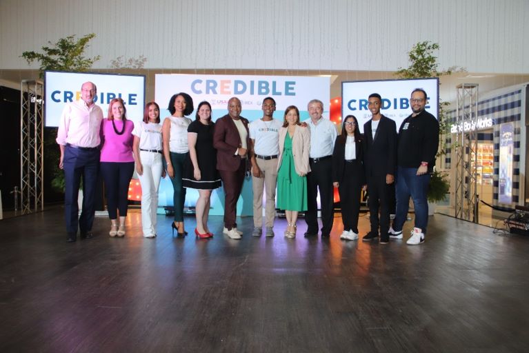 People standing together in front of CREDIBLE banner