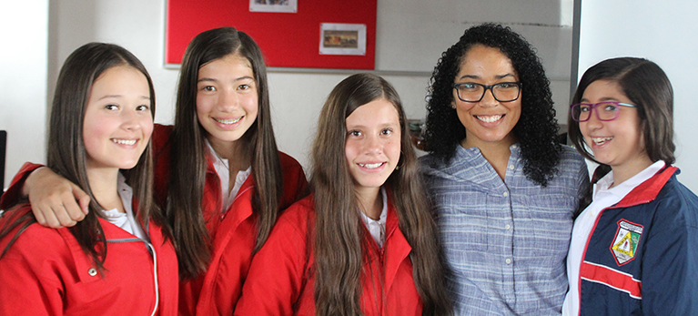 A teacher with four students in a classroom