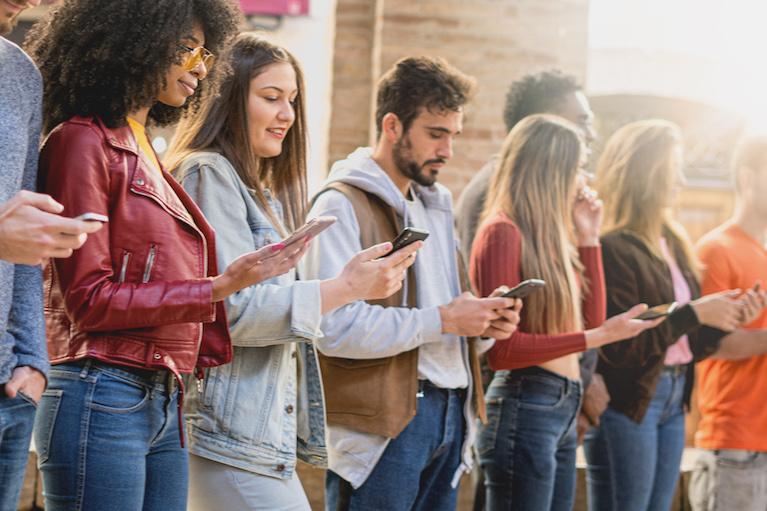 Photo of young people using mobile devices