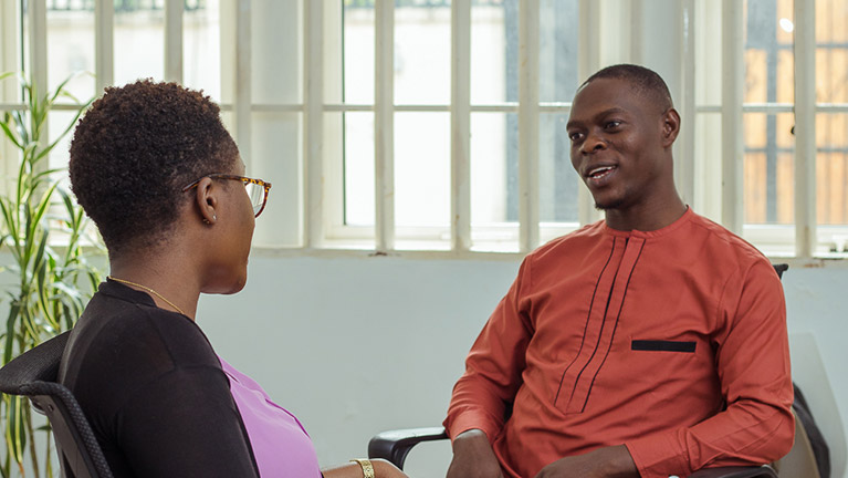 Photo of two participants talking to each other during a training session.