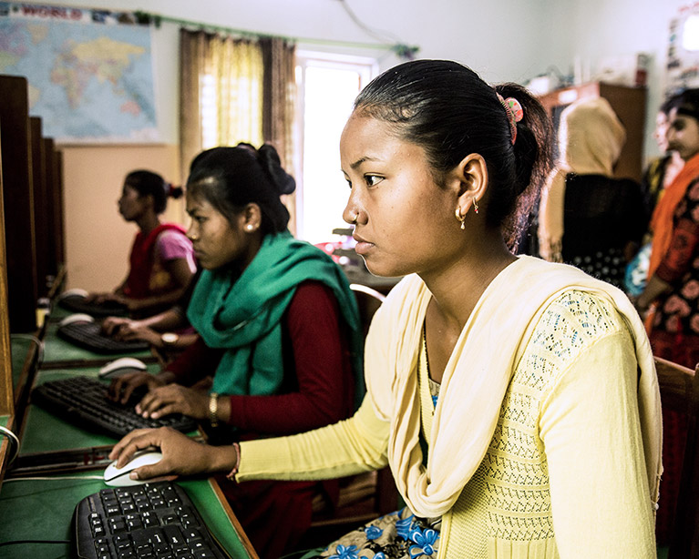 Young women using computers at a READ Center.