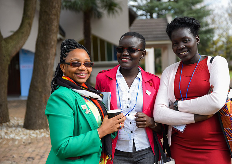 Photo of three participants talking outside.