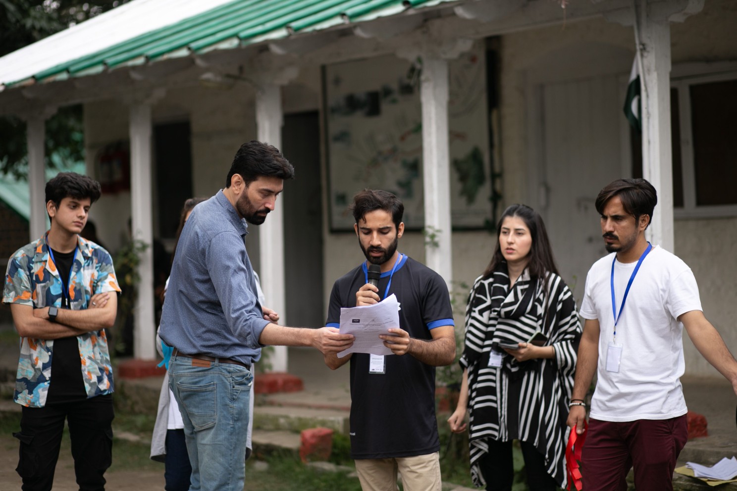 A group of people standing outside a building speaking