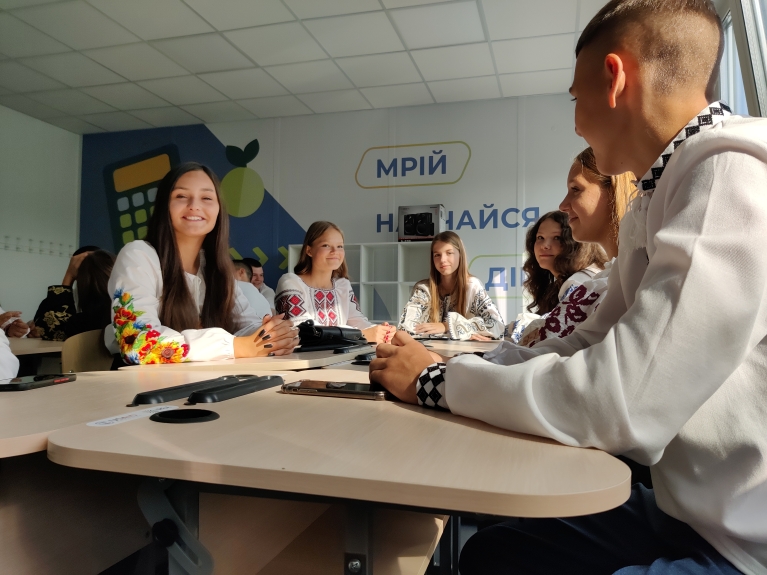 Group of young people sitting in a classroom 