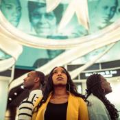 Three participants standing in a circle looking up