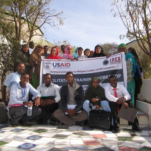 Project staff and participants with a banner about a project