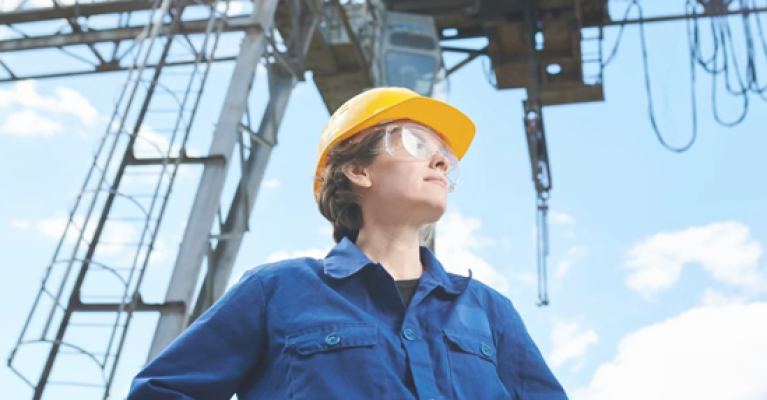A person wearing a hard hat and goggles