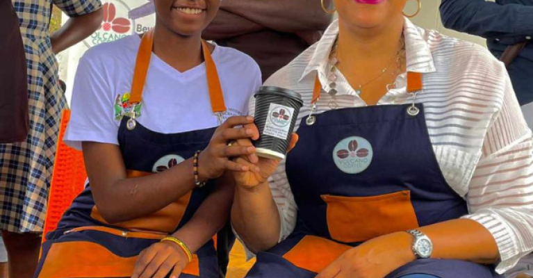 Two people sitting together holding coffee